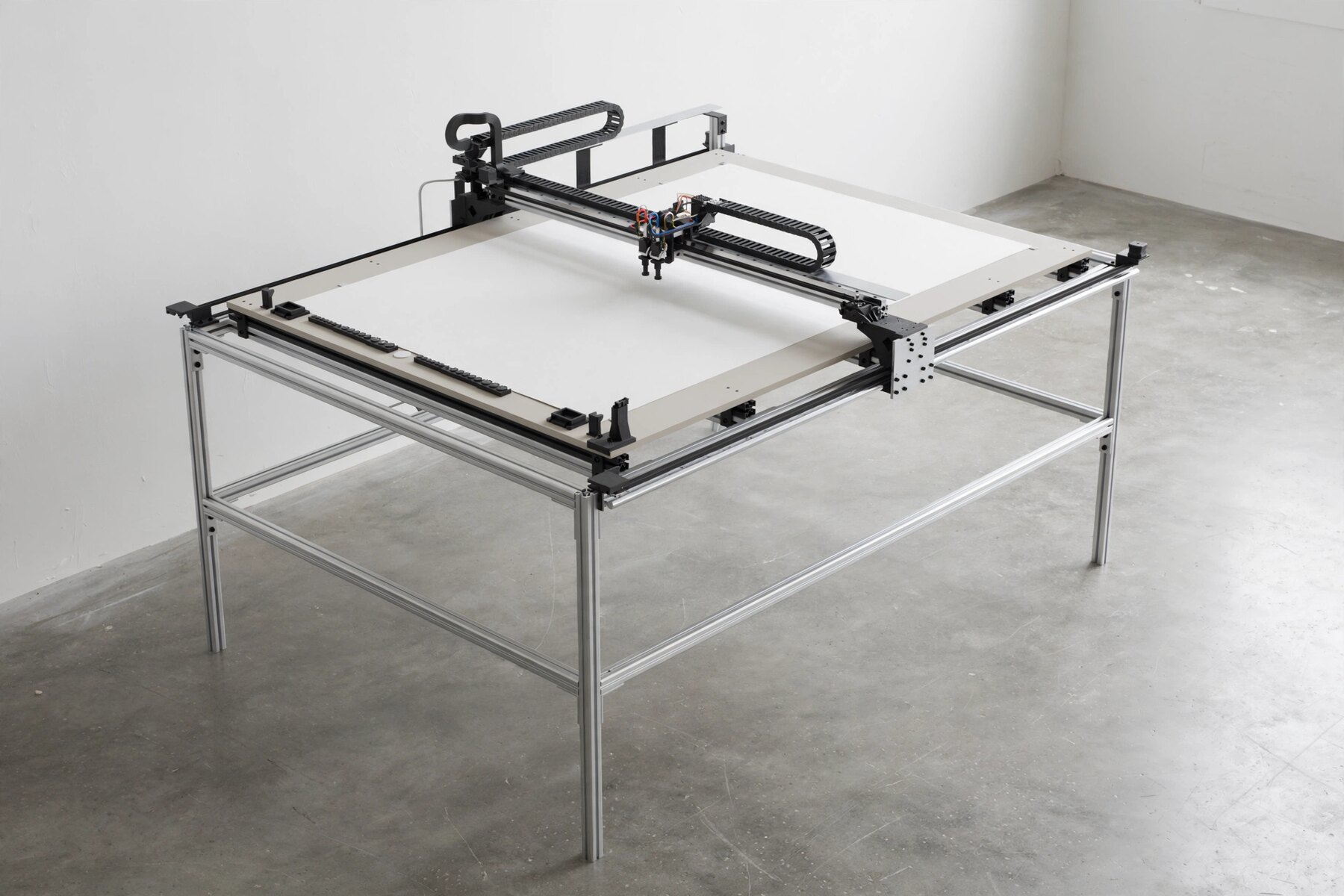 A rendering of the painting machine, a large flat table with a moving painting head above a blank sheet